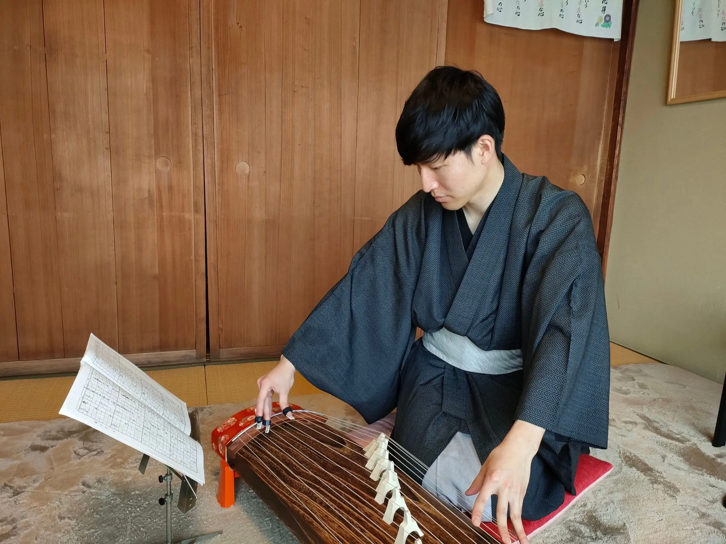 Playing koto which is a japanese traditional instrument